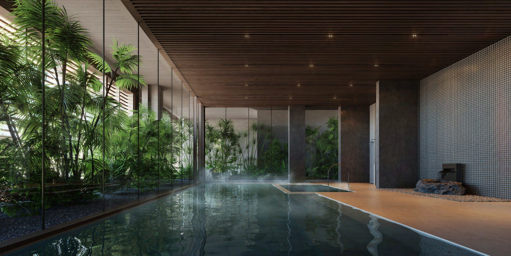 Indoor hot and cold baths beside a glass wall of tropical planting