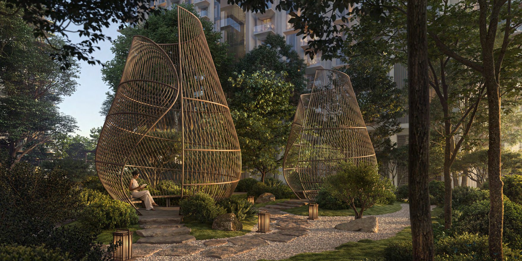 Woven pod sculptures with seating along a stone path in the garden